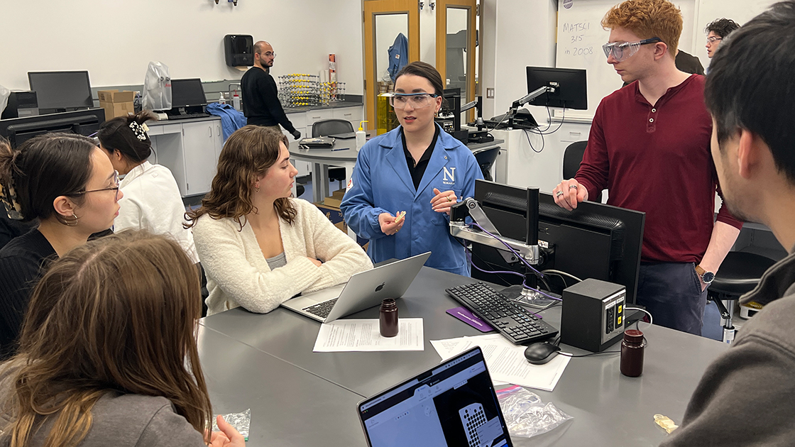 Teaching Assistants Emmy Markgraf and Alex Evenchik discuss resin formulation considerations with two student teams.