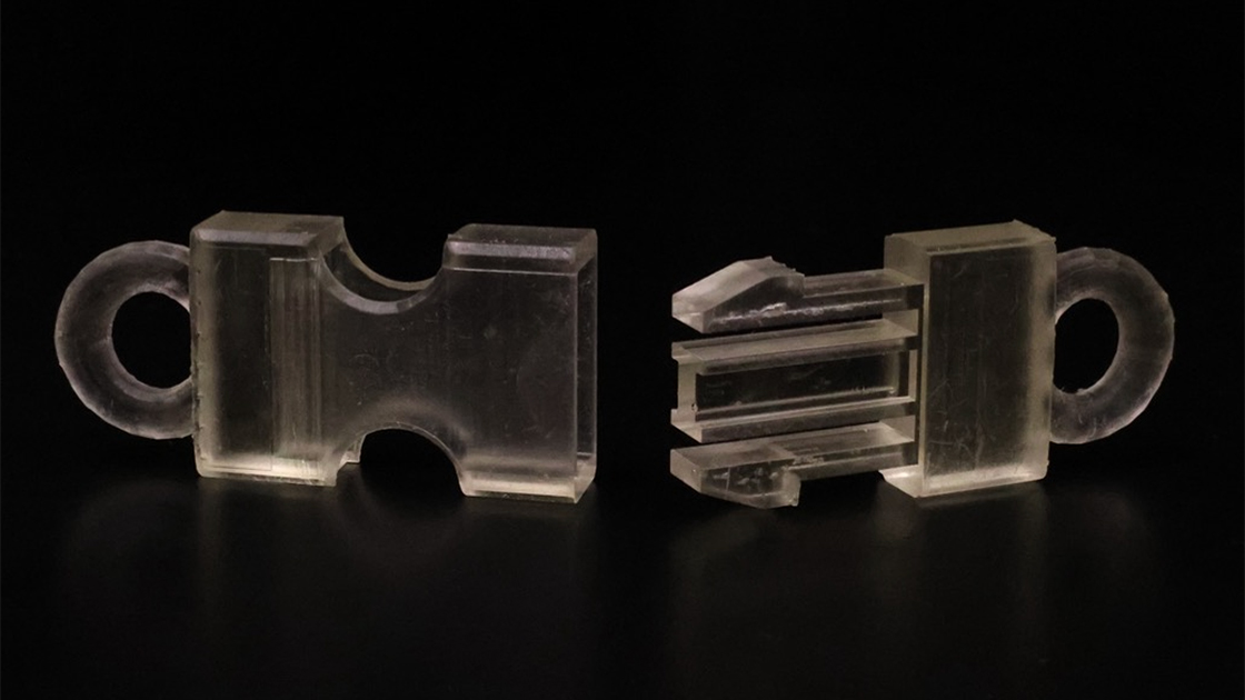 A photograph of a team’s disassembled buckle that was 3D printed with their successful custom resin.