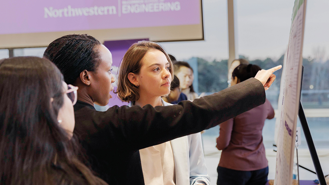 Students in front of poster presenting capstone project