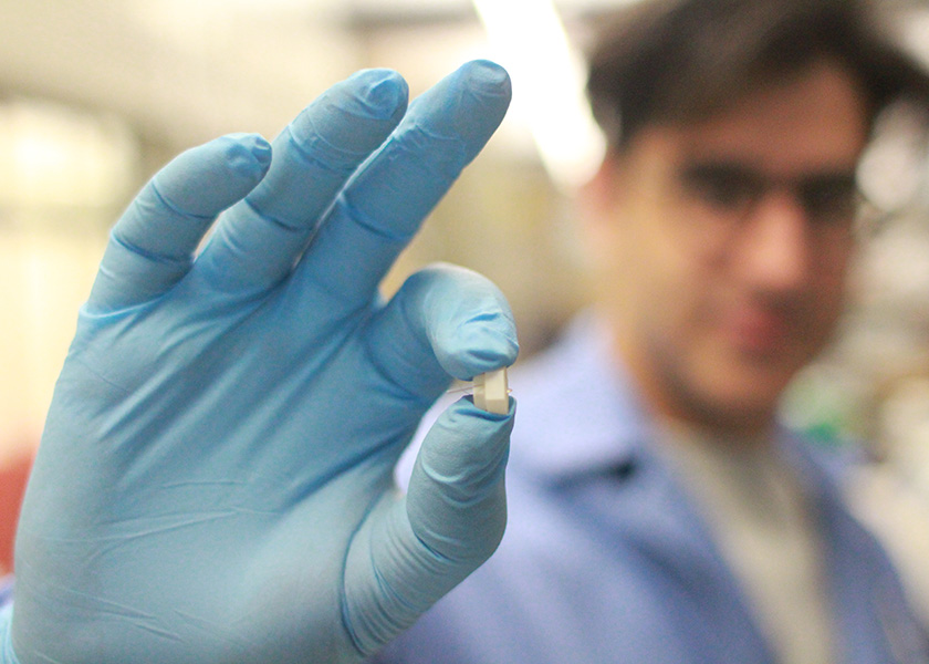 Close up of gloved hand holding device