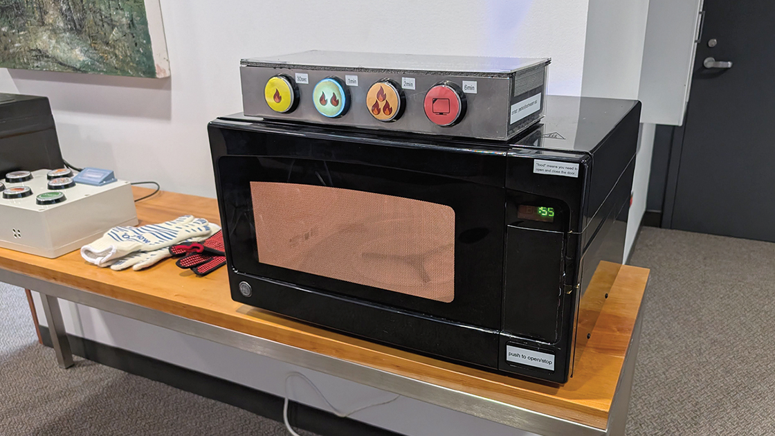 Four-button microwave interface linked to different time settings.