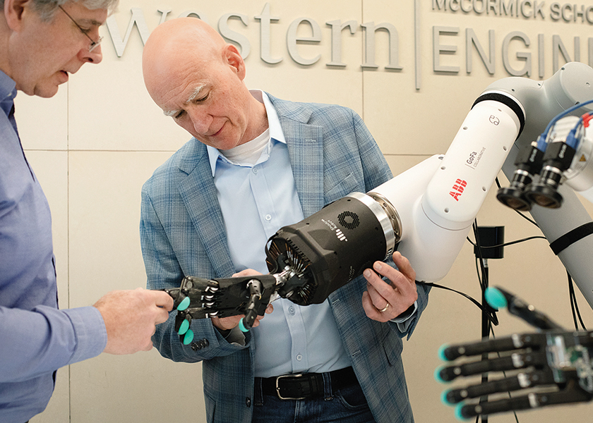 Ed Colgate examining the Dexterity Nexus robot.